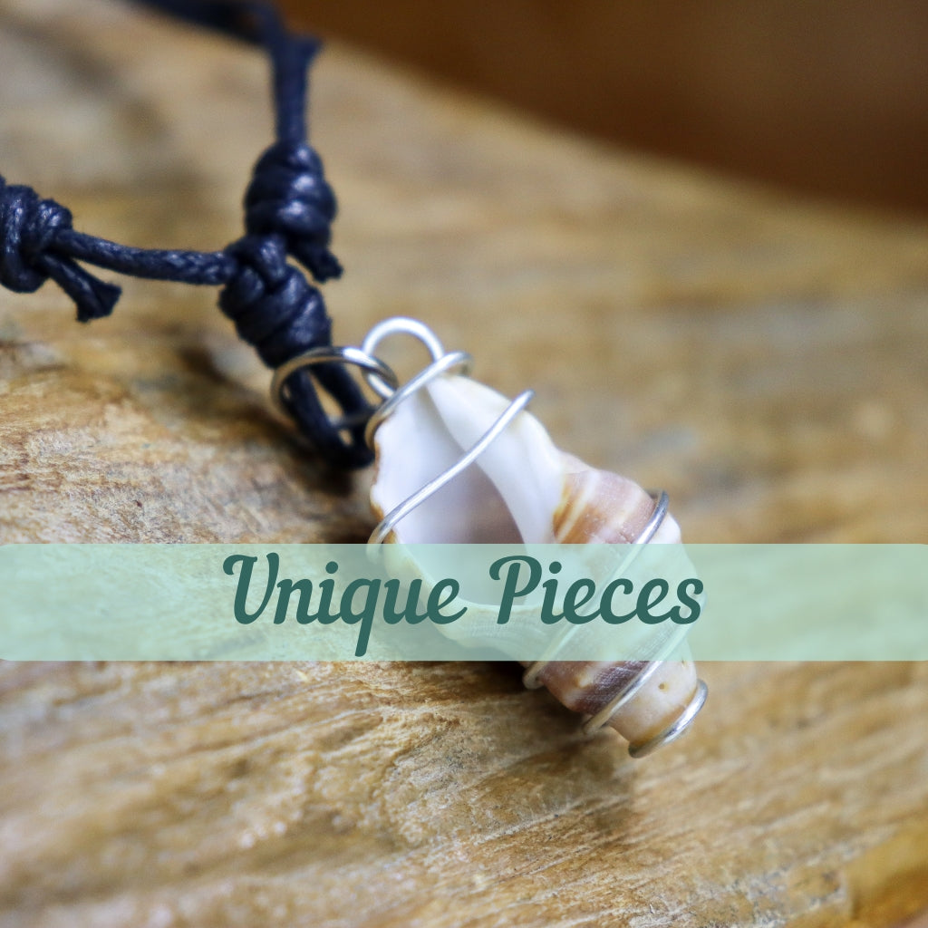 Spindle shell wrapped in silver pendant with text saying one off jewellery