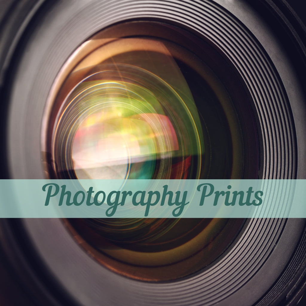 Camera lens with text saying photography prints.